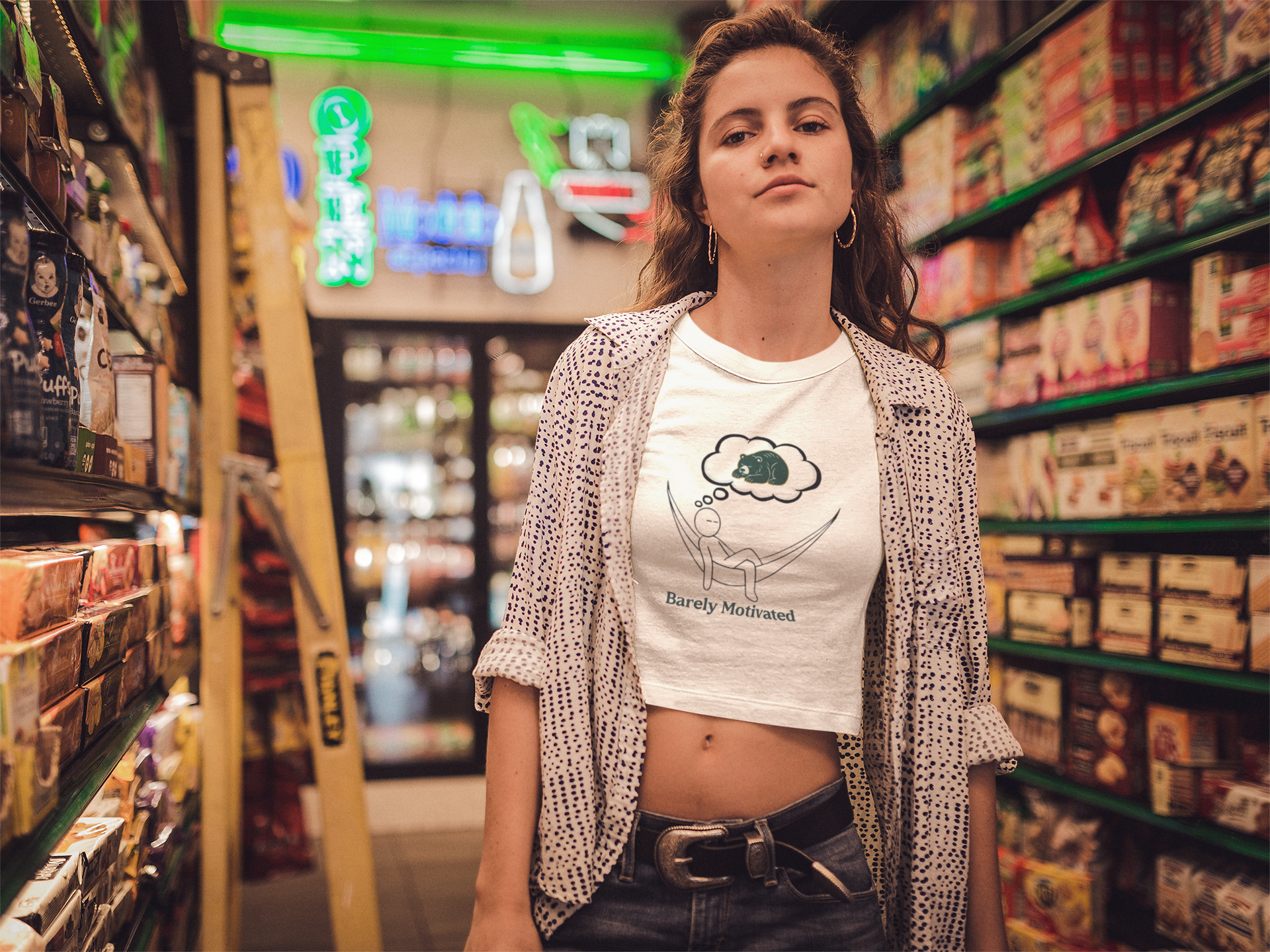 Woman standing in a store aisle with shelves stocked with products.