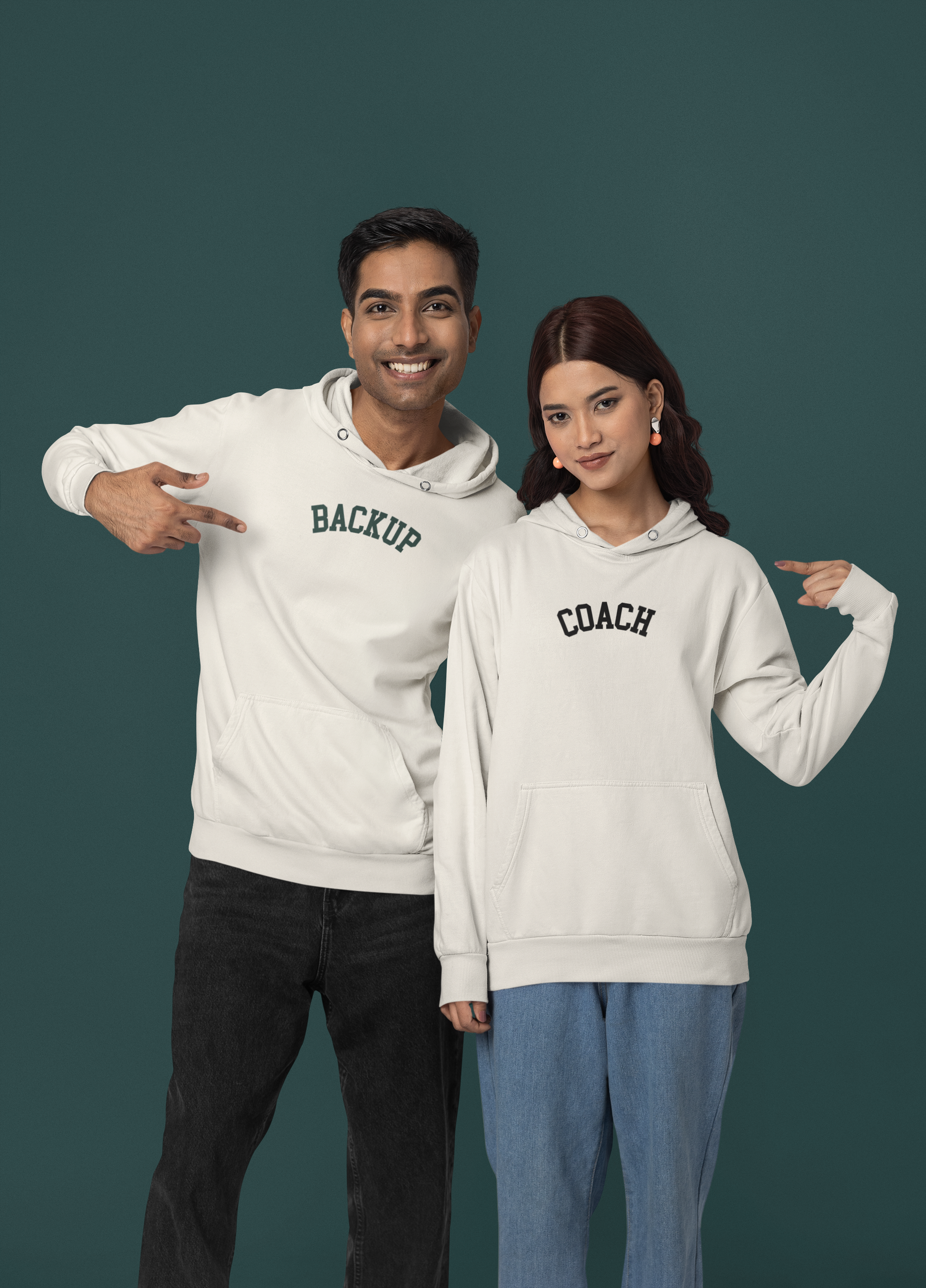 Two people wearing white hoodies with 'BACKUP' and 'COACH' text on a dark green background
