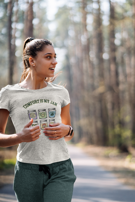 Woman wearing a t-shirt with 'Comfort is my Jam' design in a forest setting