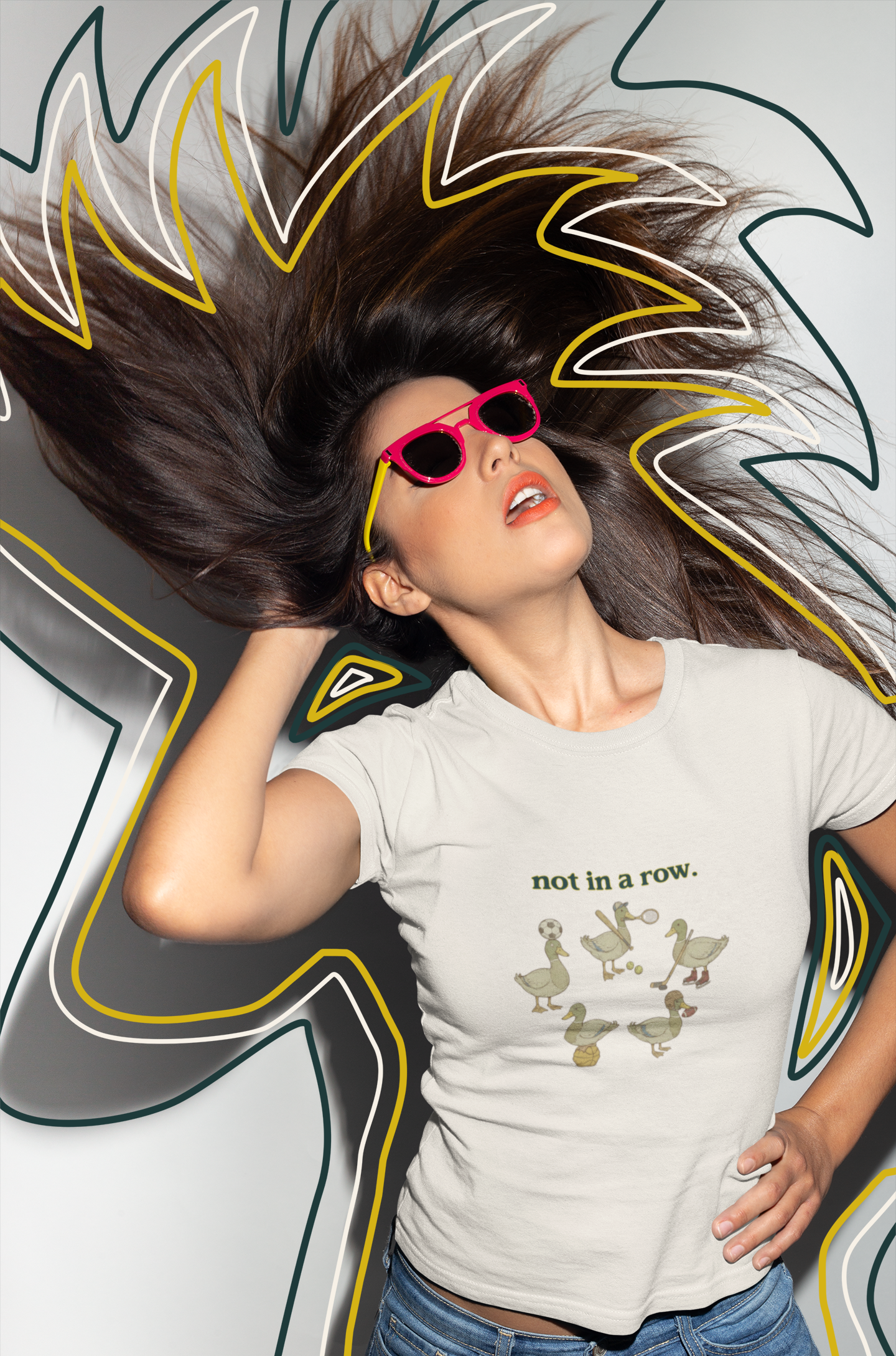 Person wearing a white t-shirt with text and graphics, standing against a colorful abstract background.