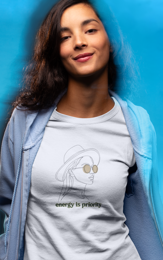Woman wearing a t-shirt with a graphic design and text against a blue background