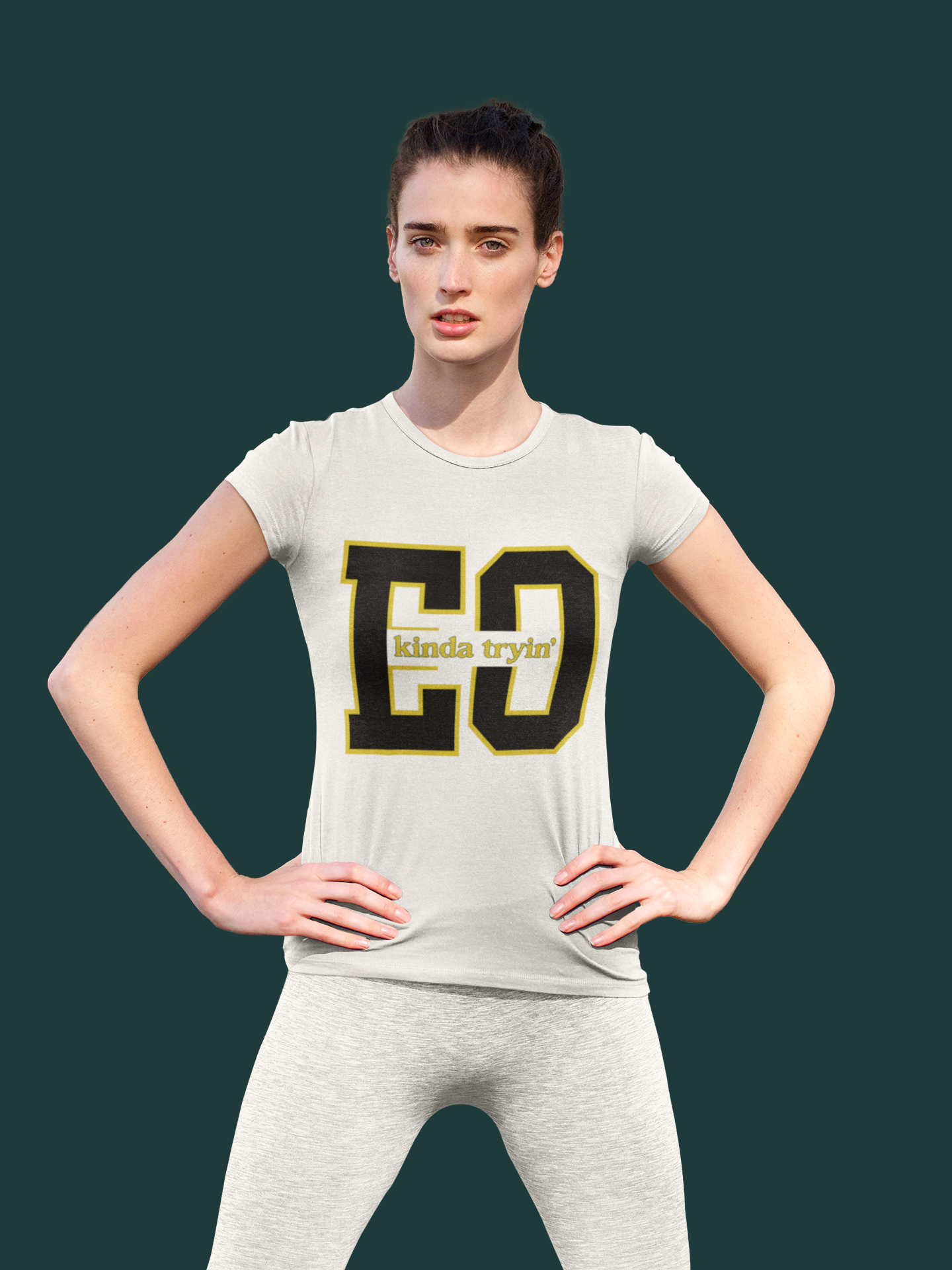 Woman wearing a gray t-shirt with 'CO kinda trying' text on a dark green background