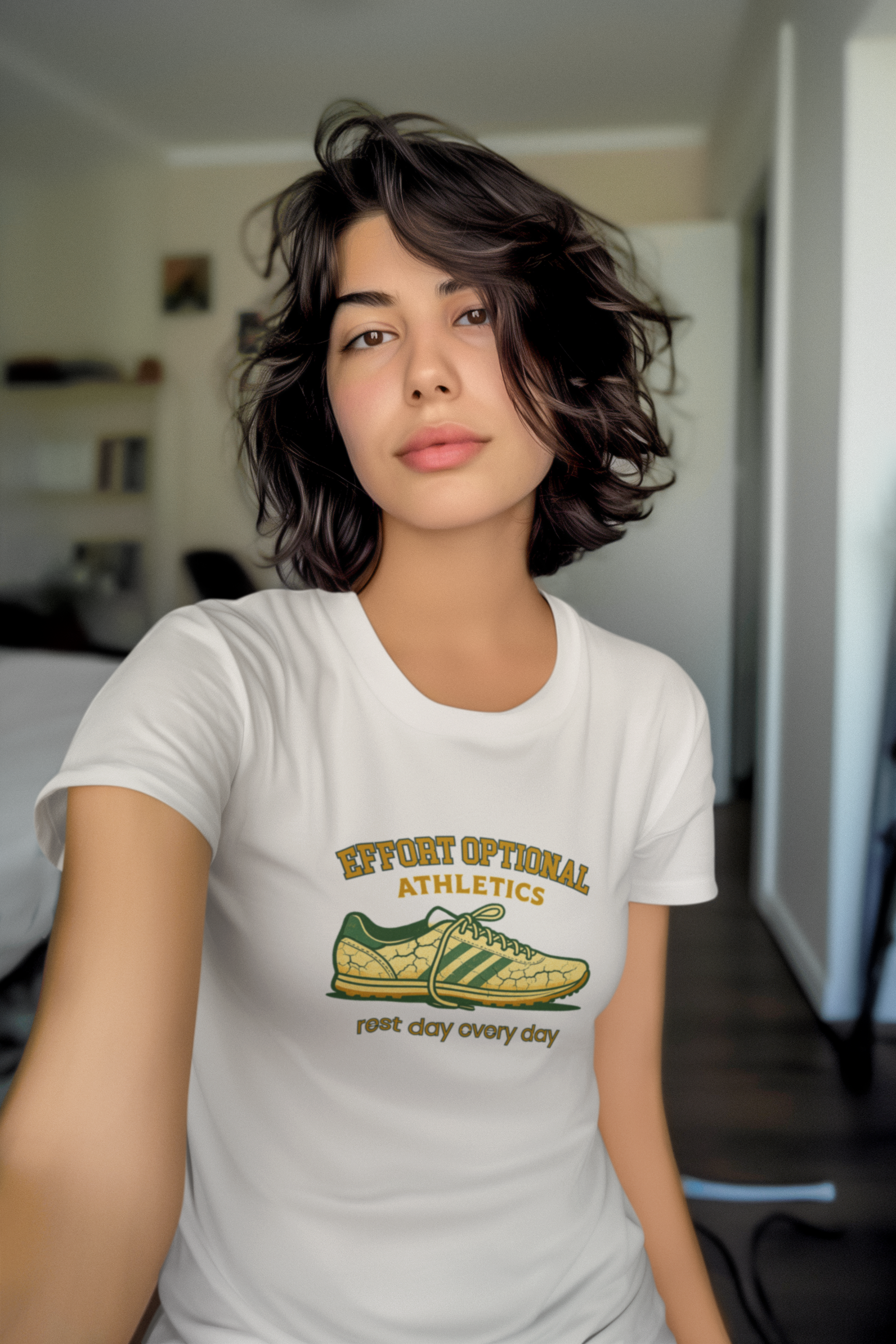 Person wearing a white t-shirt with a graphic design of a shoe and text.