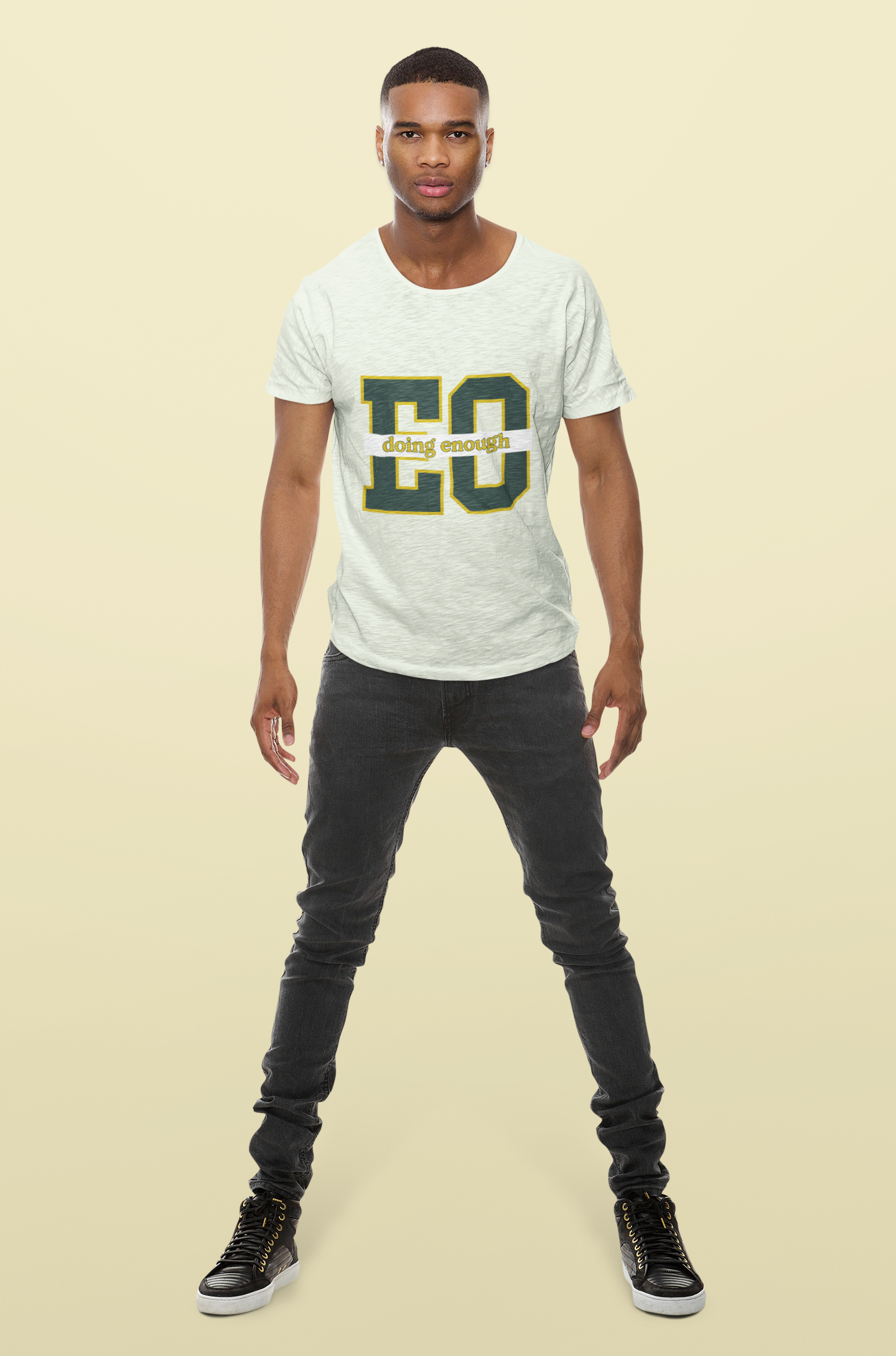 Man wearing a white t-shirt with green text on a beige background