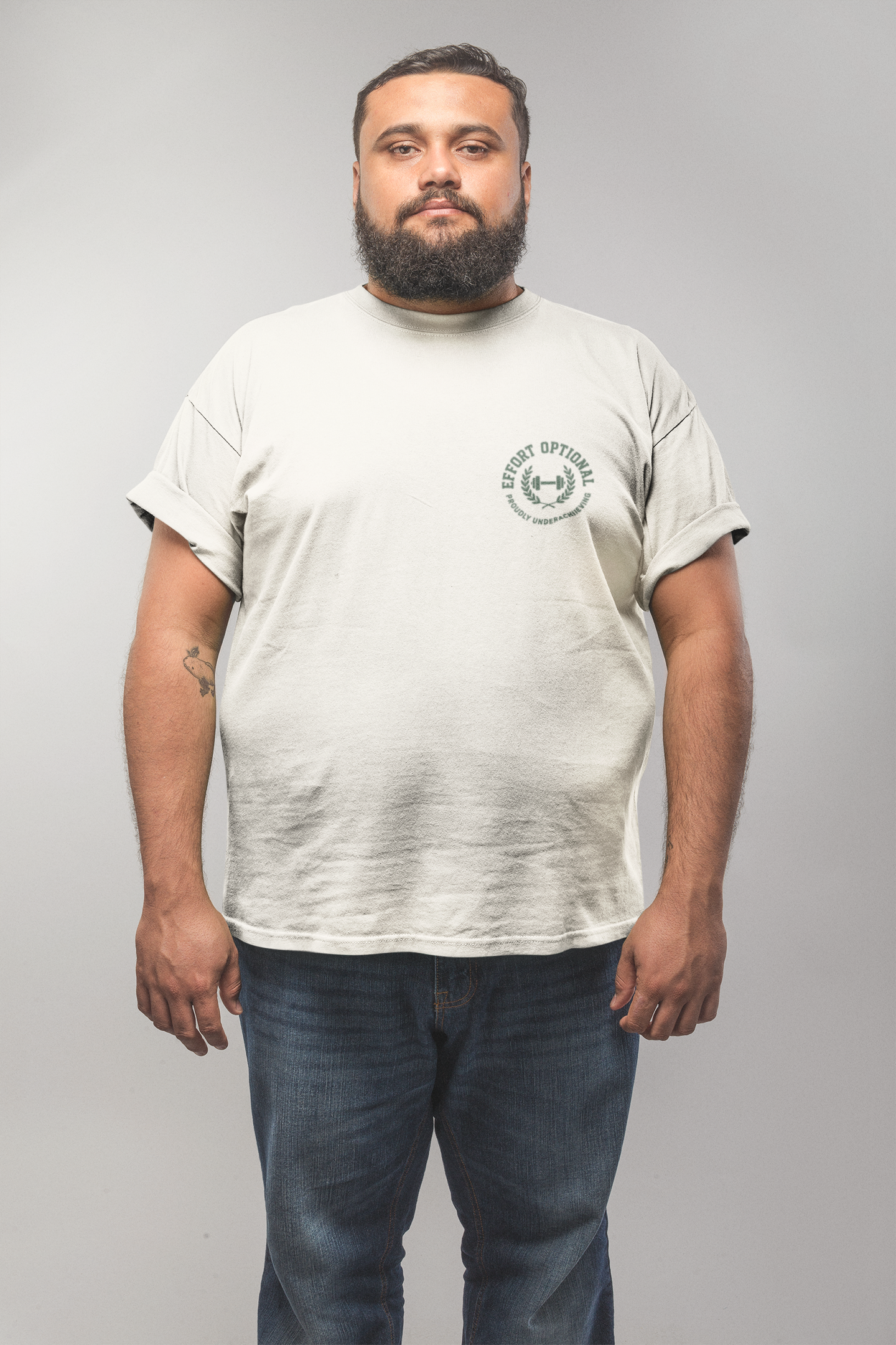 Man wearing a light gray t-shirt with a logo on a plain background