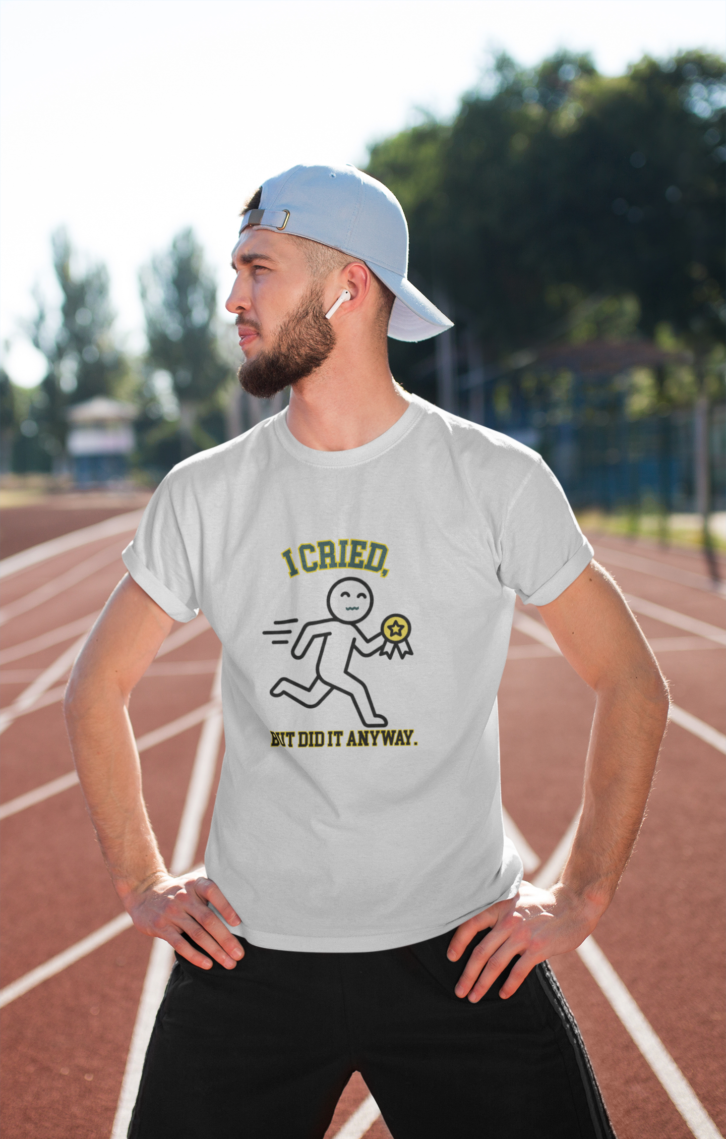 Man wearing a white t-shirt with a graphic design on a running track