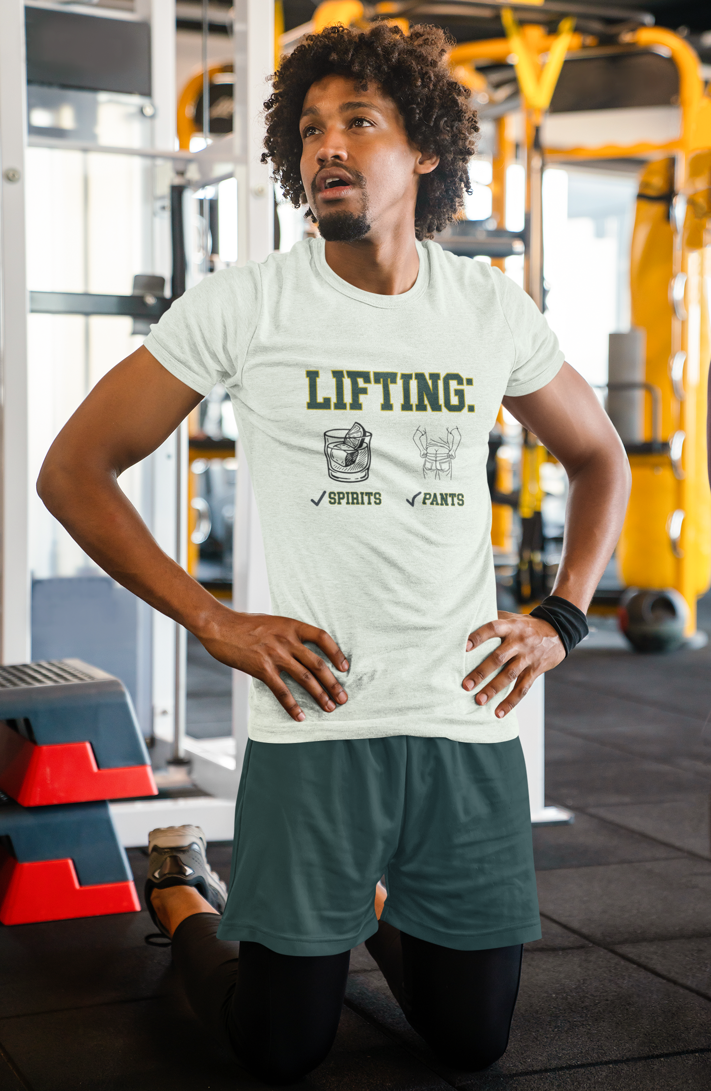 Man wearing a t-shirt with 'Lifting Spirits Pants' text in a gym setting