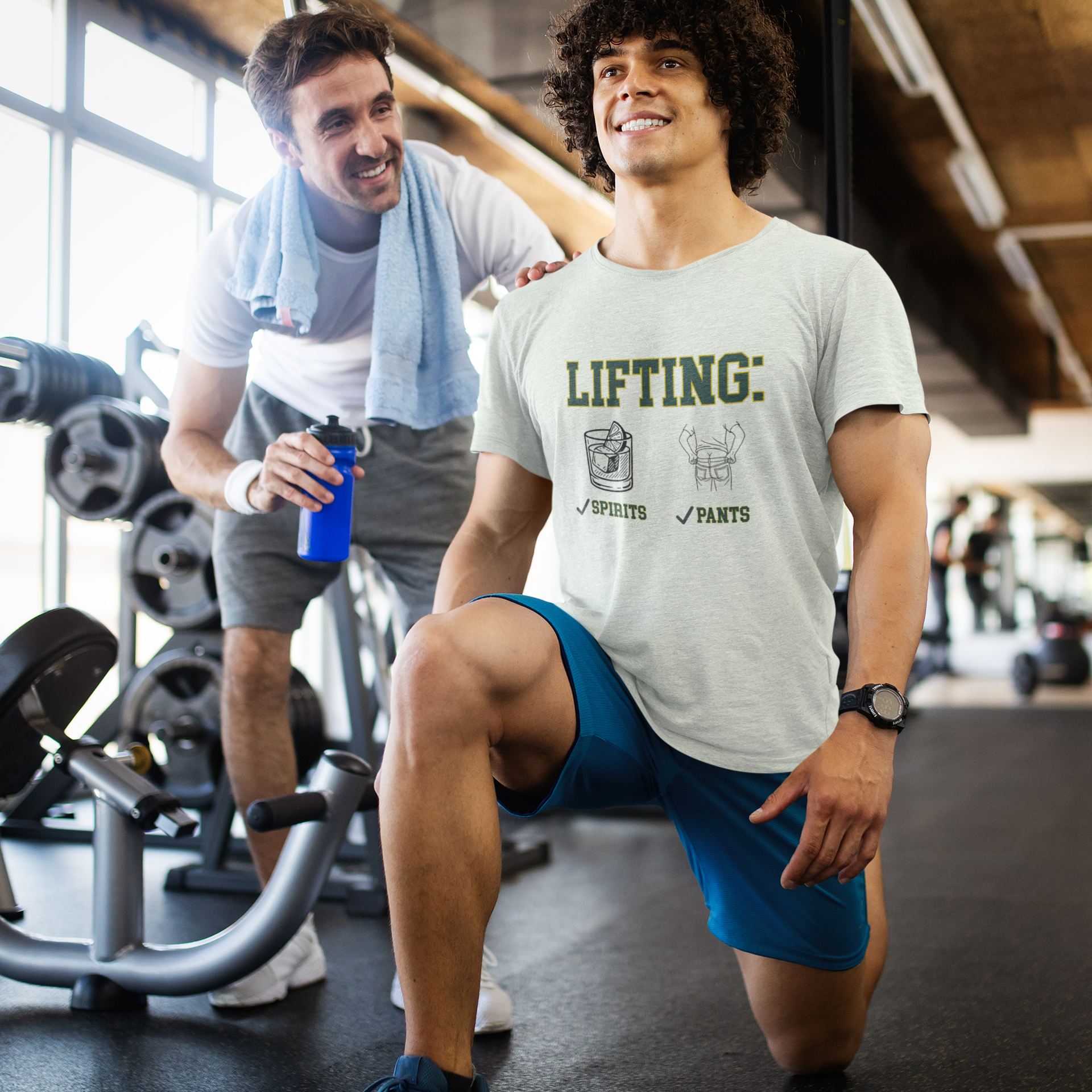 Two men in a gym setting, one performing a lunge exercise and the other holding a water bottle.
