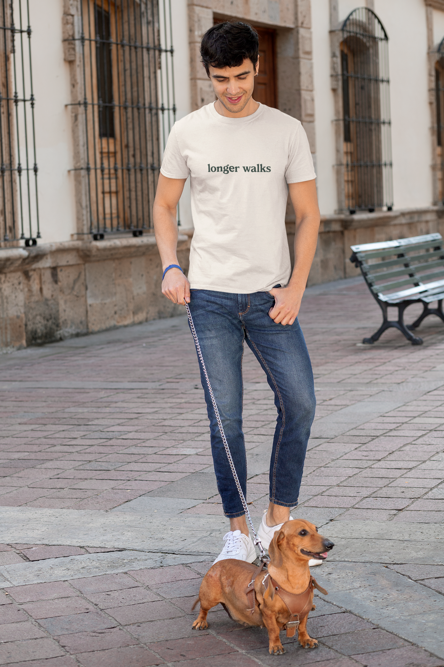 Man walking a dog on a leash in an urban setting