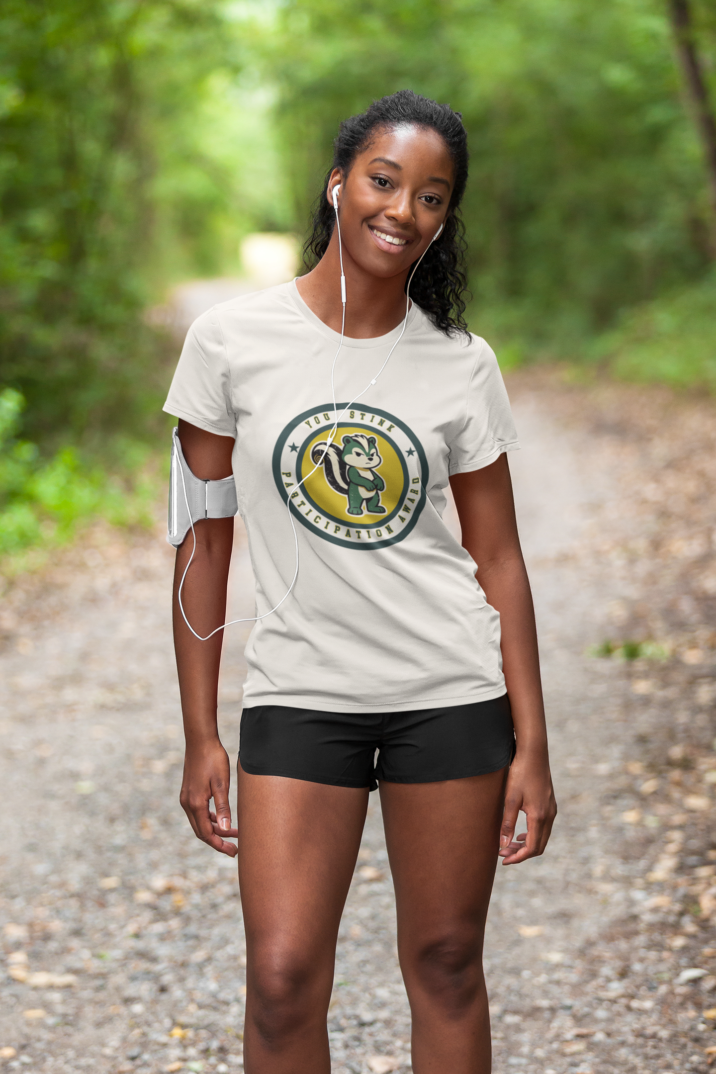 Woman wearing a white t-shirt with a logo on a forest path