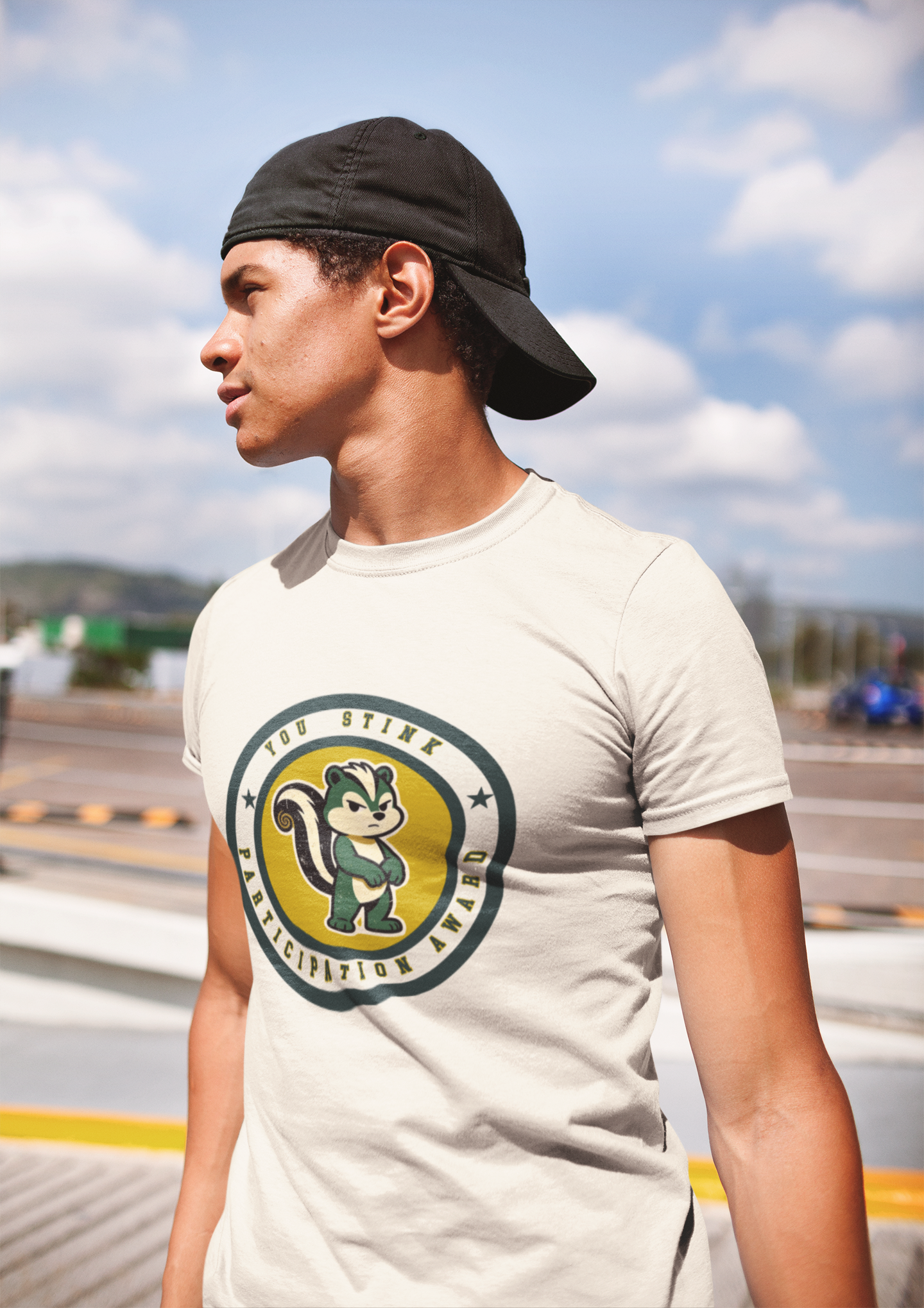 Person wearing a white t-shirt with a logo outdoors