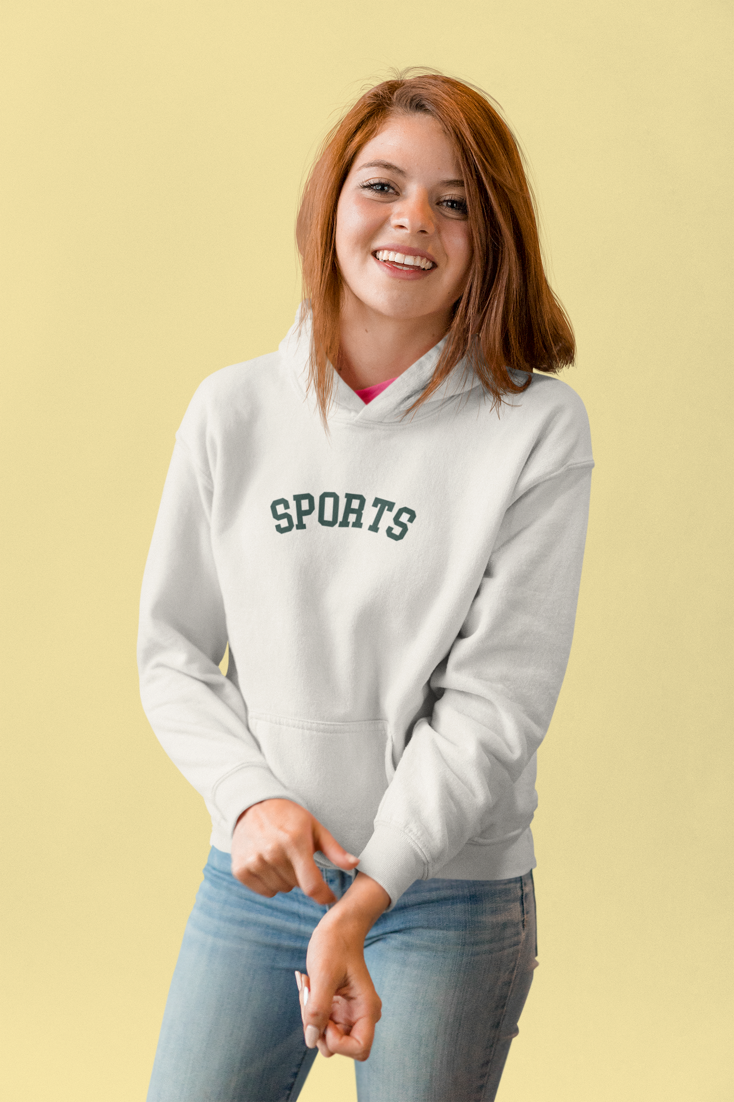 Woman wearing a gray hoodie with 'SPORTS' text on a beige background
