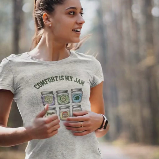 Woman wearing a t-shirt with 'Comfort is my Jam' design in a forest setting.video